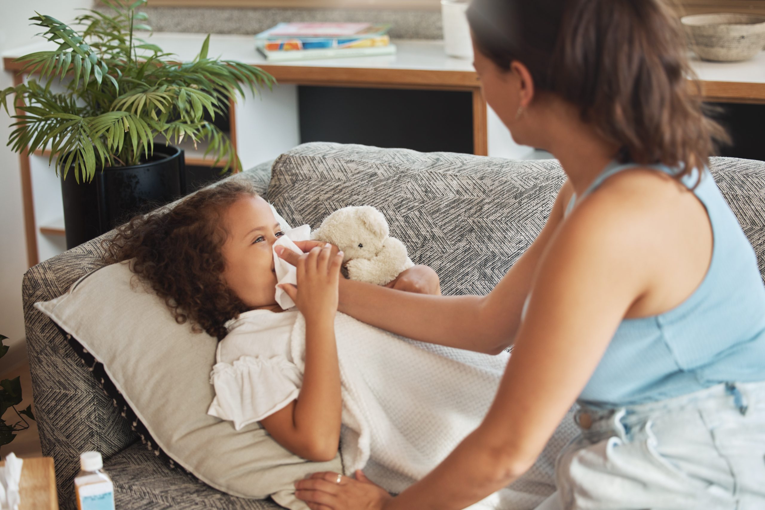 daughter-child-and-sick-girl-lying-on-sofa-while-2025-04-06-11-49-13-utc