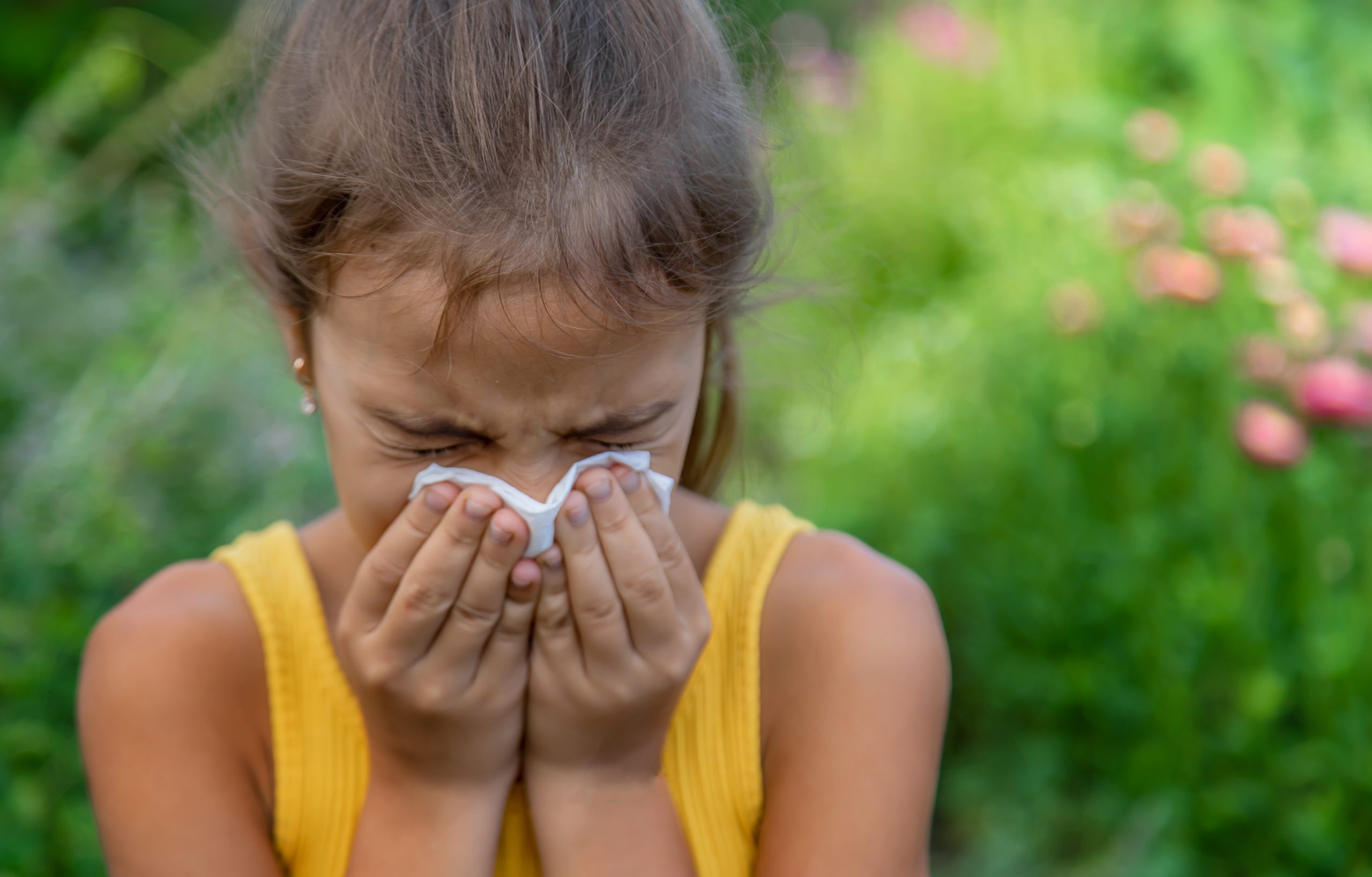 The child is seasonal allergy to flowers. Selective focus.
